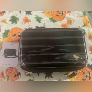 Hard black purse, green inside. Brand new with tags.